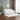 White striped sofa in a modern living room with a plant and framed picture on the wall.