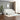 White striped sofa in a modern living room with a plant and framed picture on the wall.